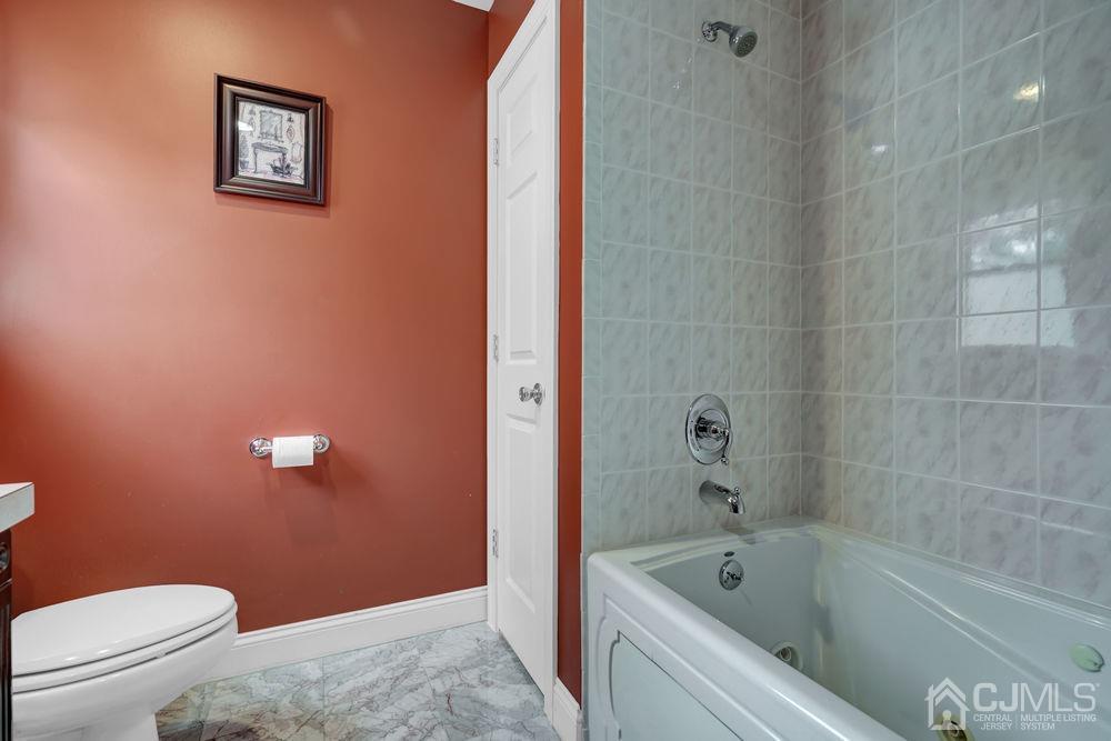 11 Kenmore Road Edison, NJ 08817 - Photo 30 of 40 a bathroom with a toilet and a bathtub