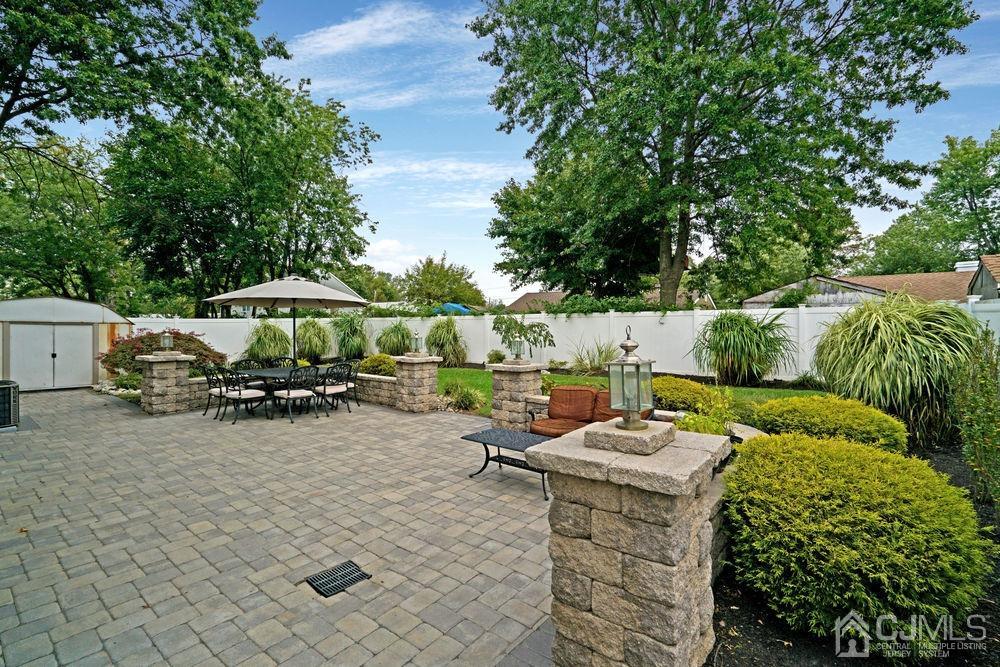 11 Kenmore Road Edison, NJ 08817 - Photo 32 of 40 a view of a patio with table and chairs under an umbrella