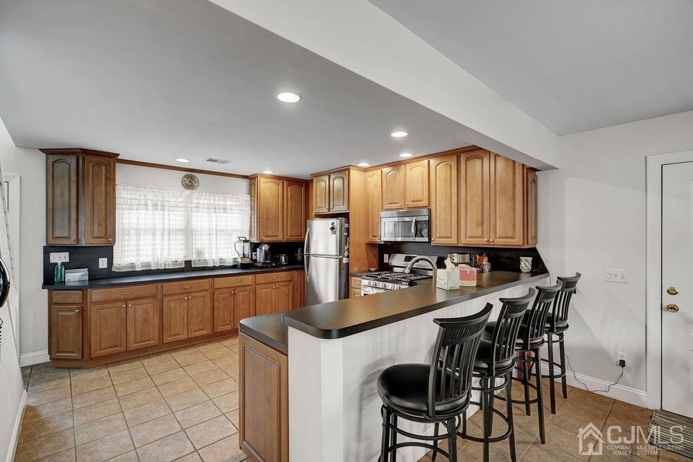 11 Kenmore Road Edison, NJ 08817 - Photo 10 of 40 a kitchen with counter top space appliances and cabinets
