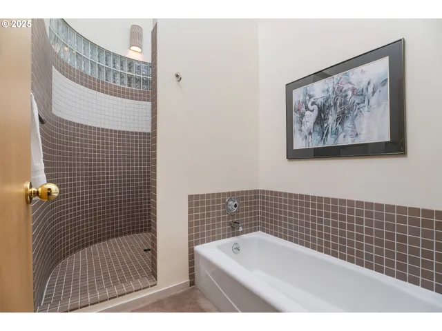 a bathroom with a bathtub and shower