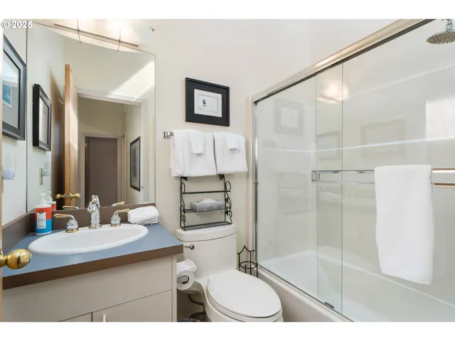 a bedroom with two beds and a large window