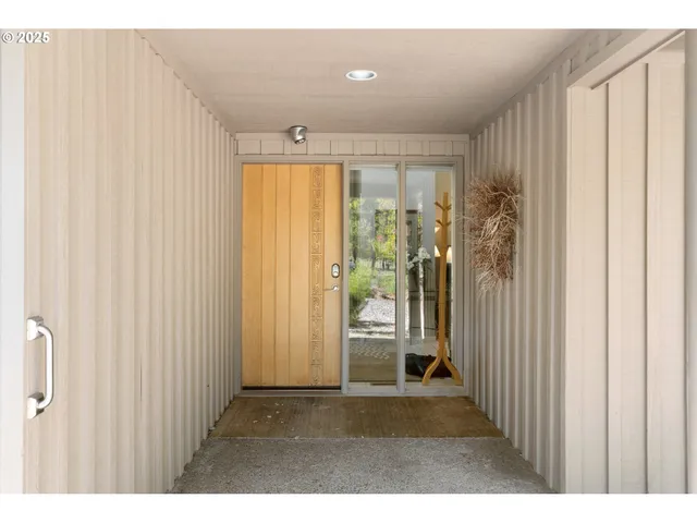 a view of a hallway with wooden shelves