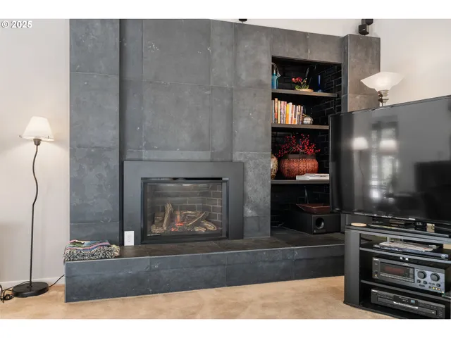 a living room with hard wood floors and a fireplace