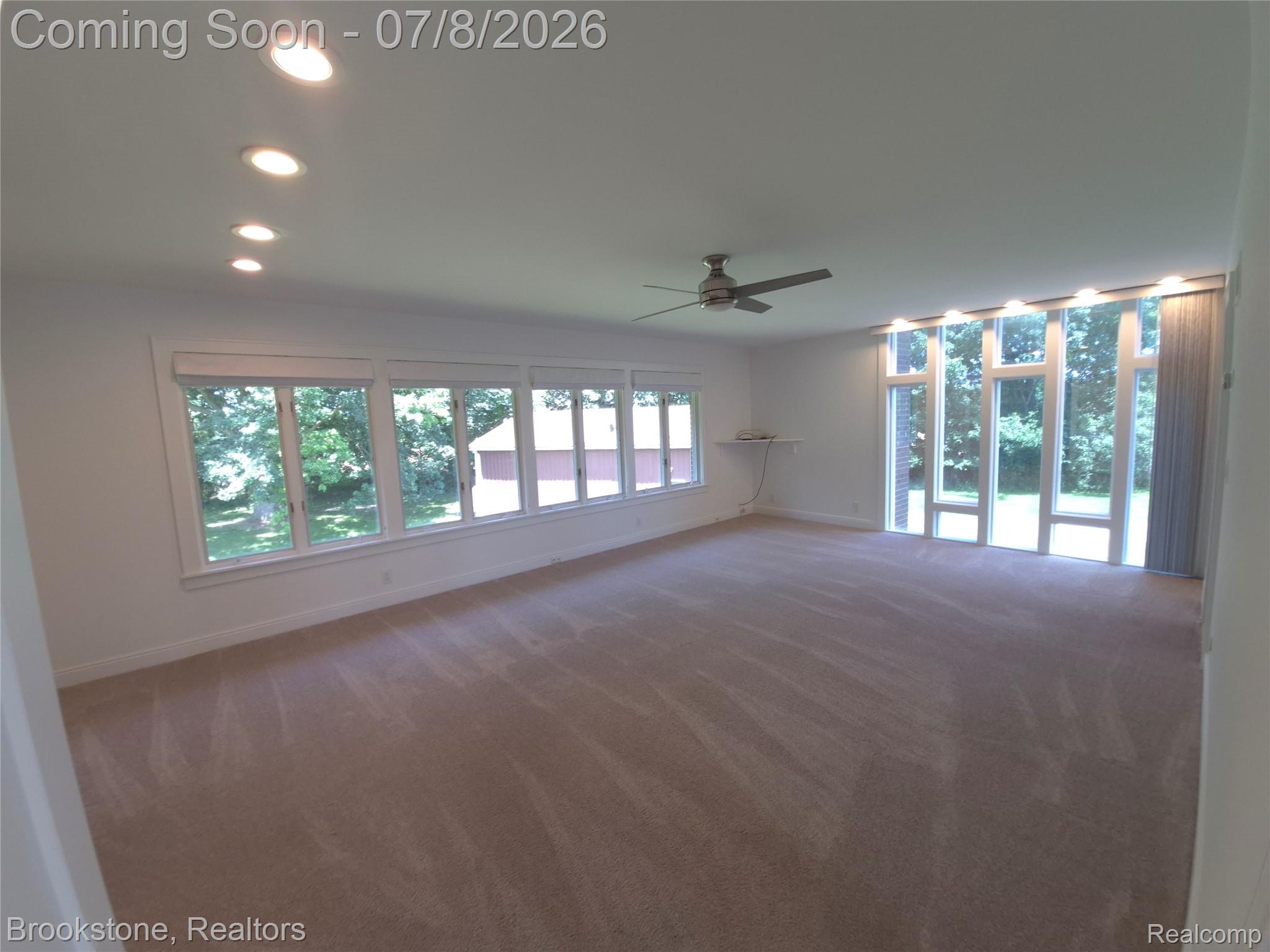 4140 South Henderson Road Davison, MI 48423 - Photo 38 of 98 Expansive room with neutral carpeting and a white ceiling