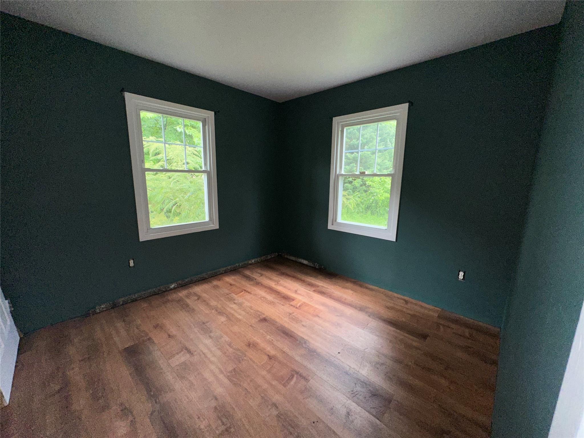 77 Lincoln Road Medford, NY 11763 - Photo 7 of 14 a view of an empty room with window and wooden floor