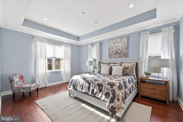 a bedroom with a large bed and a painting on the wall