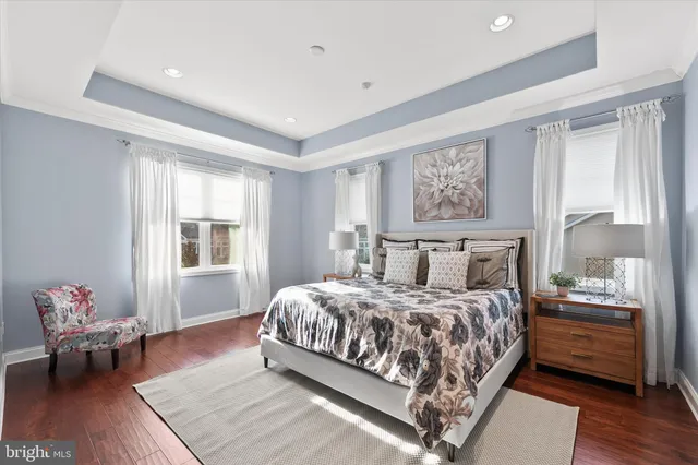 a bedroom with a large bed and a painting on the wall