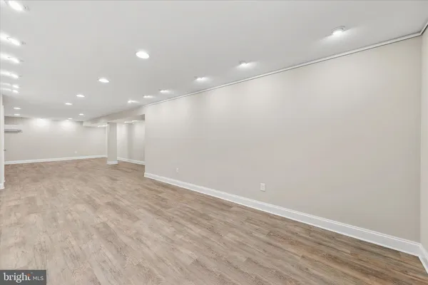 a view of an empty room with wooden floors