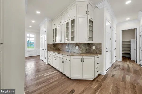 a kitchen with granite countertop white cabinets and stainless steel appliances