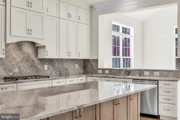 a kitchen with stainless steel appliances granite countertop a sink and a stove