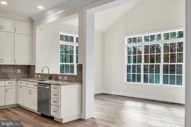 a kitchen with a stove a sink and a window
