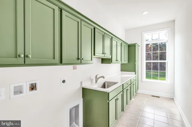 a bathroom with a sink a bathtub and next to a window