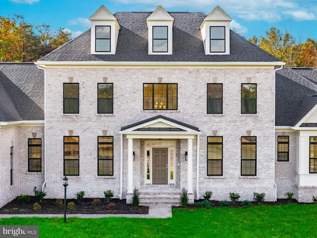 front view of a brick house with a yard
