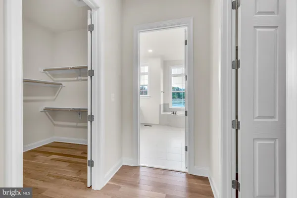 a view of a hallway with wooden floor