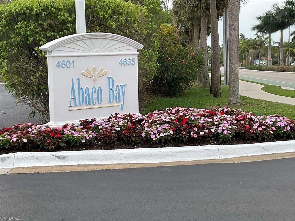 a view of sign board with flower garden