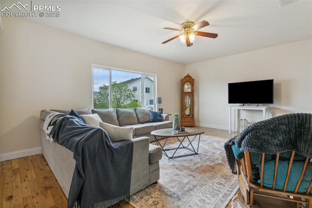 12229 Crystal Downs Road Peyton, CO 80831 - Photo 11 of 47 a living room with furniture and a flat screen tv