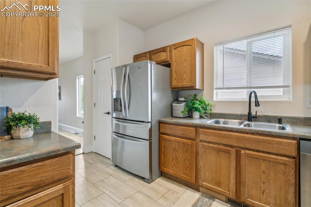 12229 Crystal Downs Road Peyton, CO 80831 - Photo 16 of 47 a kitchen with appliances a sink and cabinets