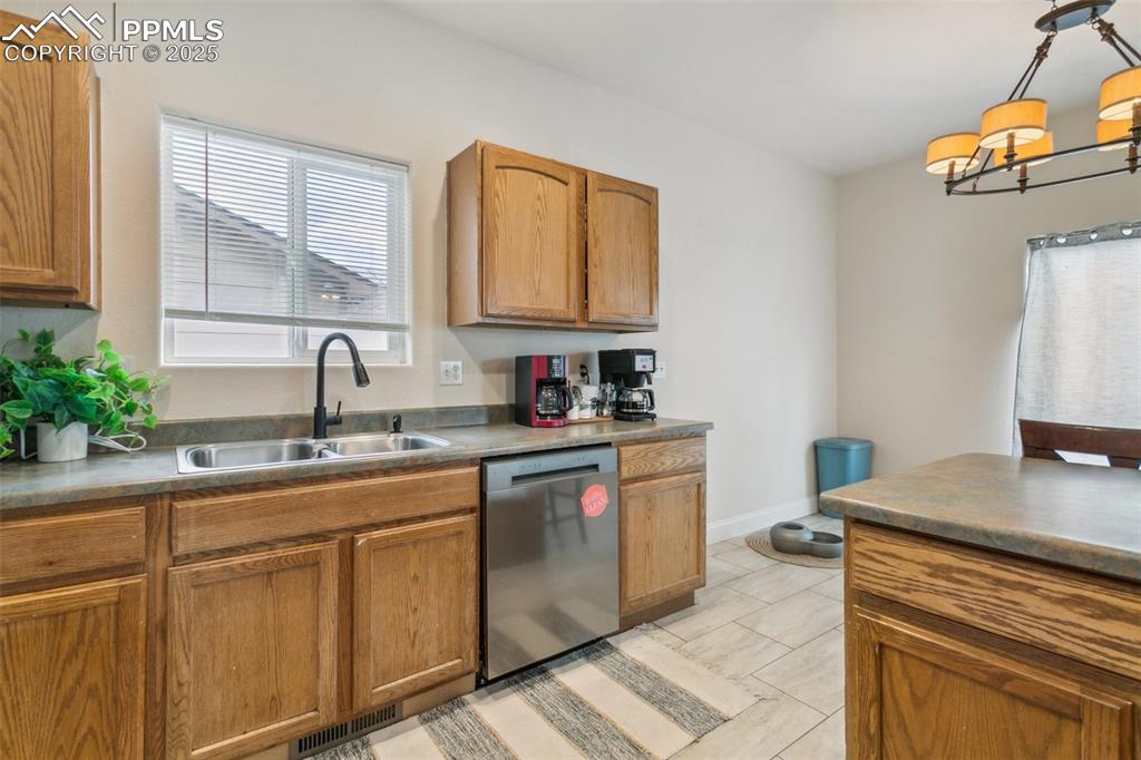 12229 Crystal Downs Road Peyton, CO 80831 - Photo 17 of 47 a kitchen with cabinets a sink and dishwasher