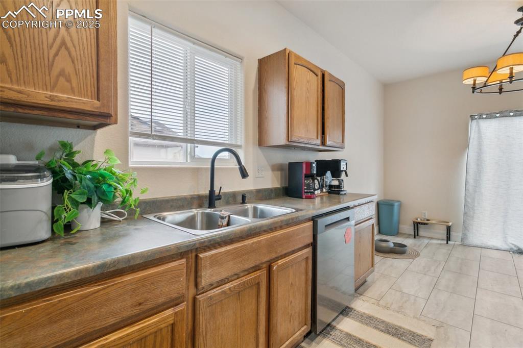 12229 Crystal Downs Road Peyton, CO 80831 - Photo 19 of 47 a kitchen with a sink and a refrigerator
