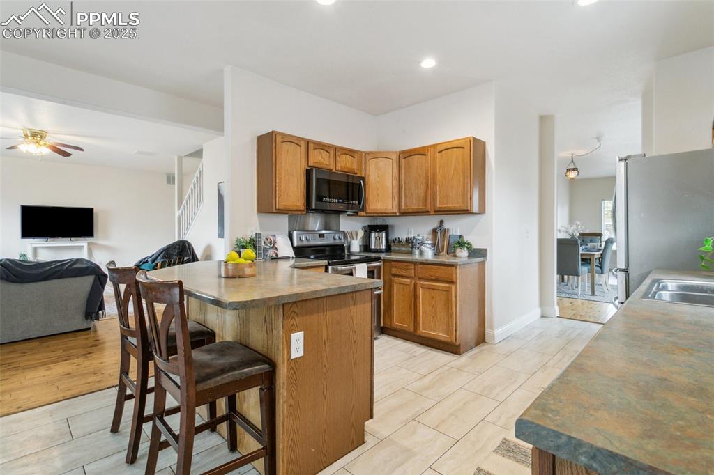 12229 Crystal Downs Road Peyton, CO 80831 - Photo 20 of 47 a kitchen with a sink a counter top space appliances and cabinets