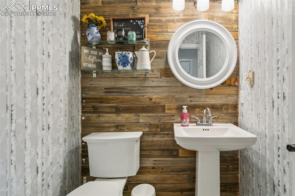 12229 Crystal Downs Road Peyton, CO 80831 - Photo 24 of 47 a bathroom with a sink mirror and toilet