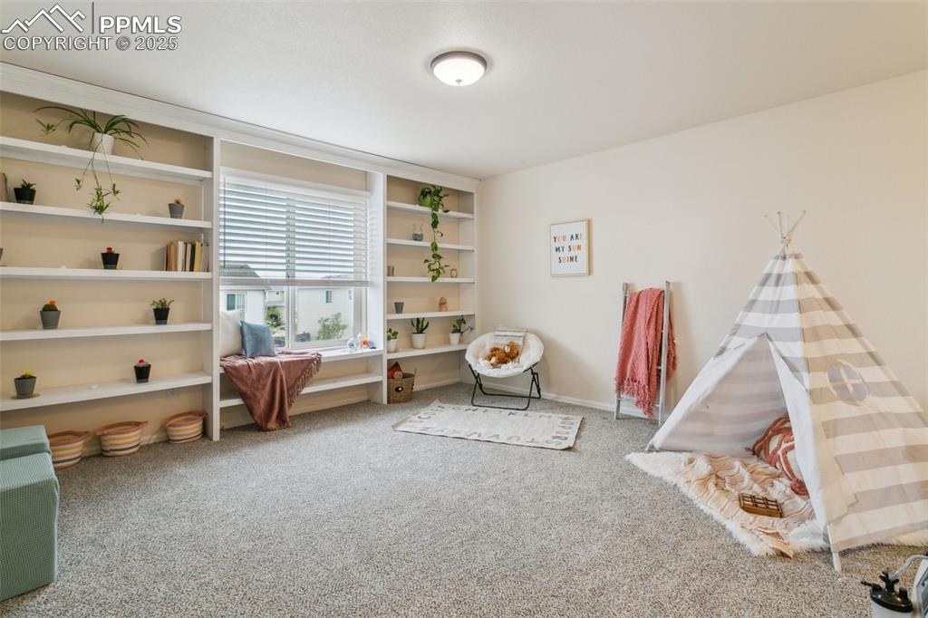 12229 Crystal Downs Road Peyton, CO 80831 - Photo 26 of 47 a bedroom with furniture and a wooden floor