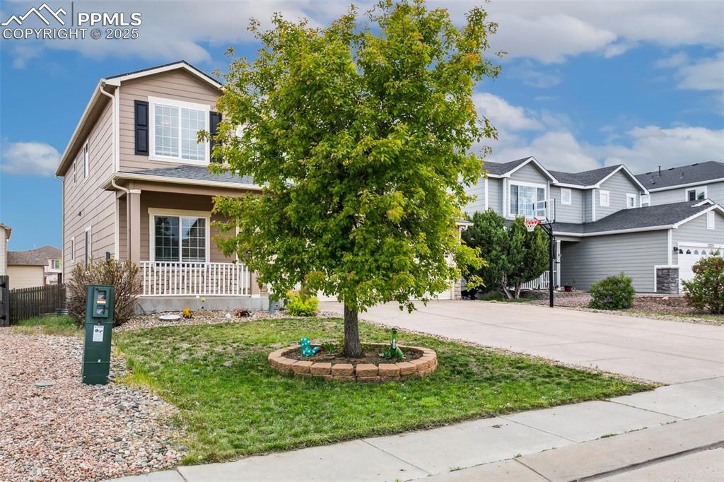 12229 Crystal Downs Road Peyton, CO 80831 - Photo 3 of 47 a front view of a house with a yard and garage
