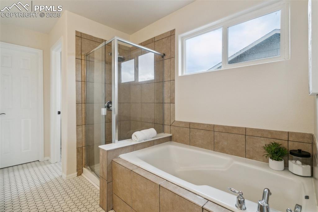 12229 Crystal Downs Road Peyton, CO 80831 - Photo 33 of 47 a bathroom with a tub a sink and a shower