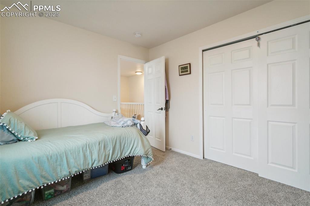 12229 Crystal Downs Road Peyton, CO 80831 - Photo 38 of 47 a bedroom with a bed and a painting on the wall