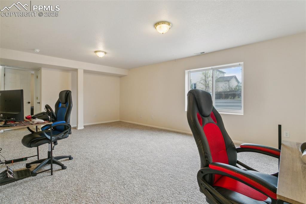 12229 Crystal Downs Road Peyton, CO 80831 - Photo 39 of 47 a room with furniture and a wooden floor