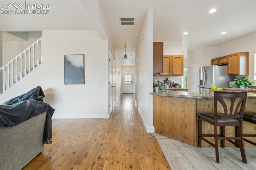 12229 Crystal Downs Road Peyton, CO 80831 - Photo 10 of 47 a living room with furniture and a wooden floor