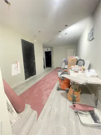 a living room with a sink furniture and a flat screen tv