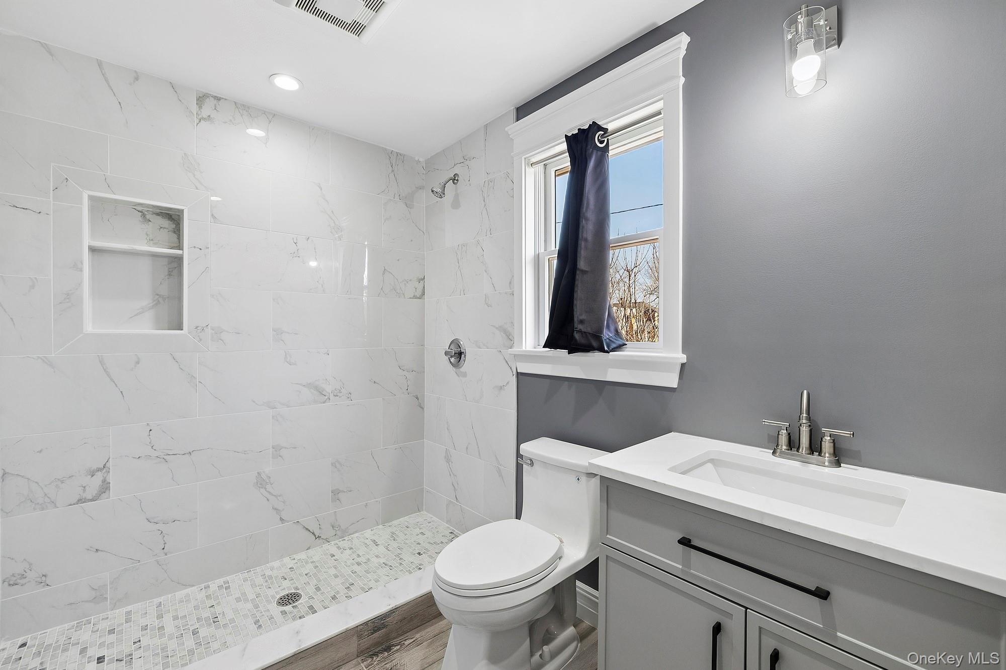 178 Main Road Riverhead, NY 11901 - Photo 11 of 28 a bathroom with a toilet sink and mirror