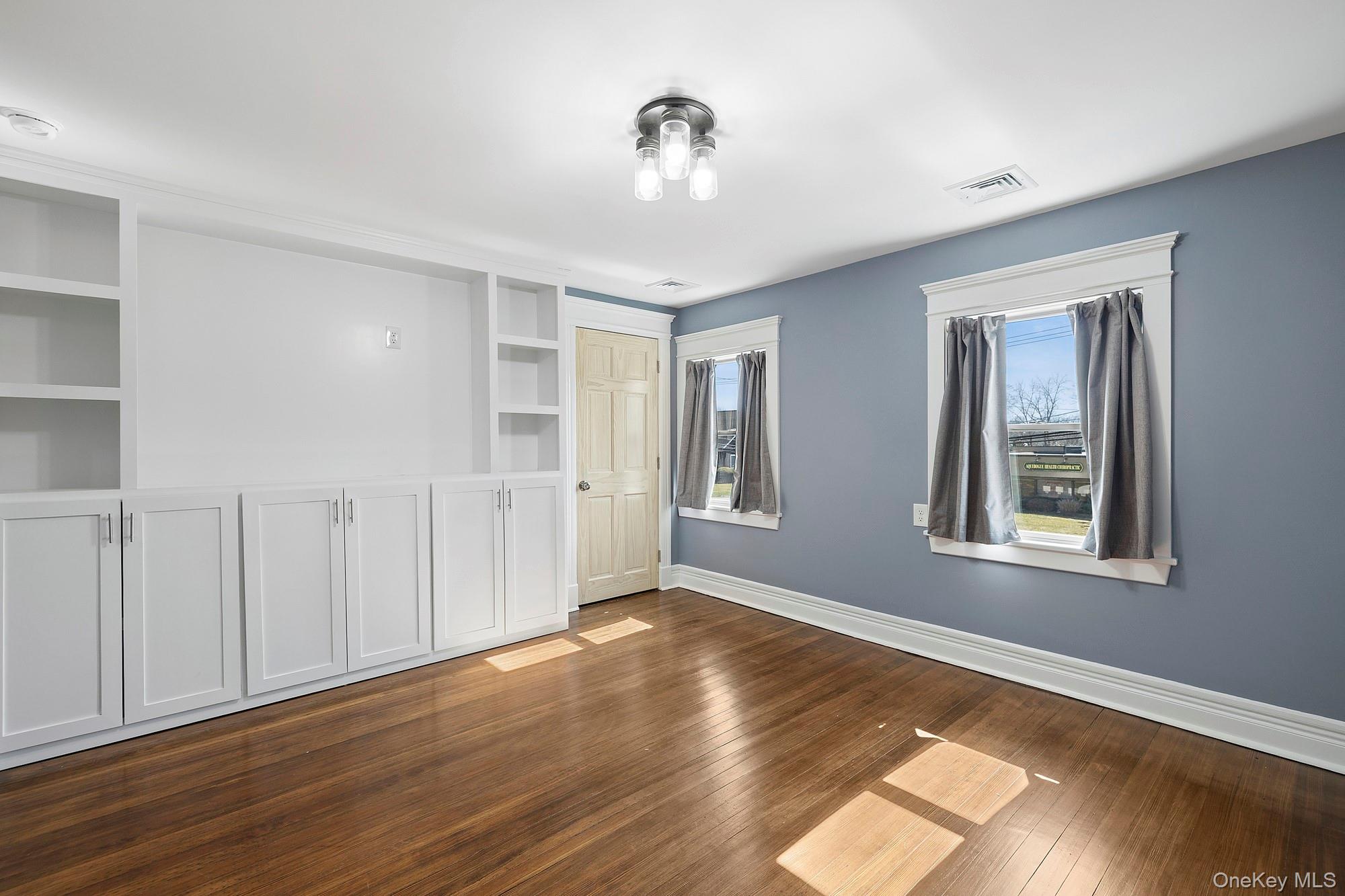 178 Main Road Riverhead, NY 11901 - Photo 19 of 28 a view of an empty room with wooden floor and a window