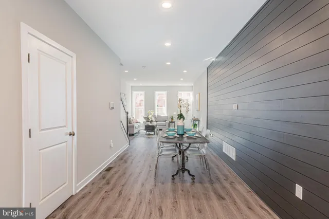 a view of a room with furniture and wooden floor