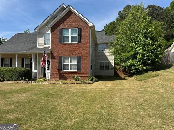 a front view of a house with a yard