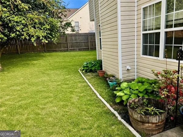 a front view of house with yard and trees