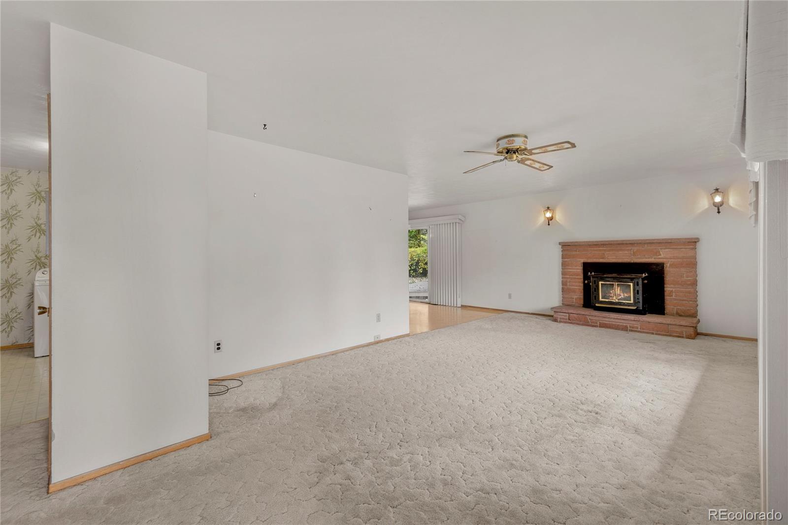 12590 Jay Road Erie, CO 80516 - Photo 4 of 25 a view of an empty room with a fireplace