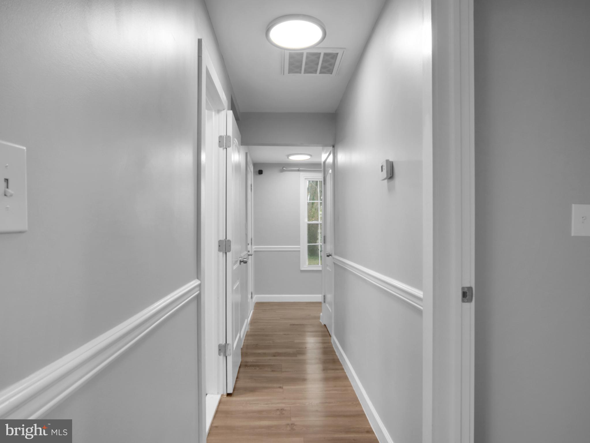 125 Valley Road Aberdeen, MD 21001 - Photo 19 of 24 a view of a hallway with wooden floor and a bathroom