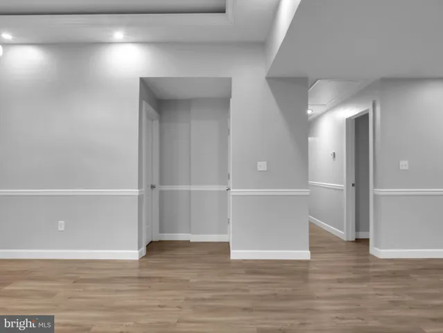 a view of a room with wooden floor