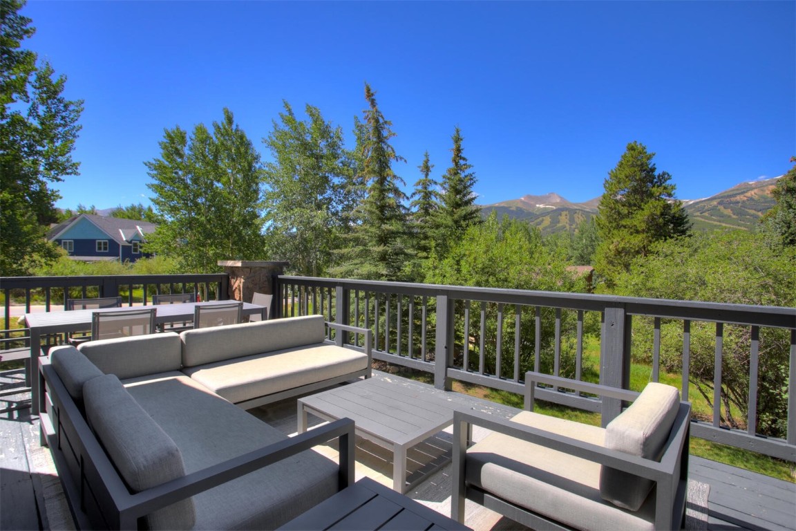 203 Wellington Road Breckenridge, CO 80424 - Photo 14 of 42 a view of a patio with wooden chairs and a table
