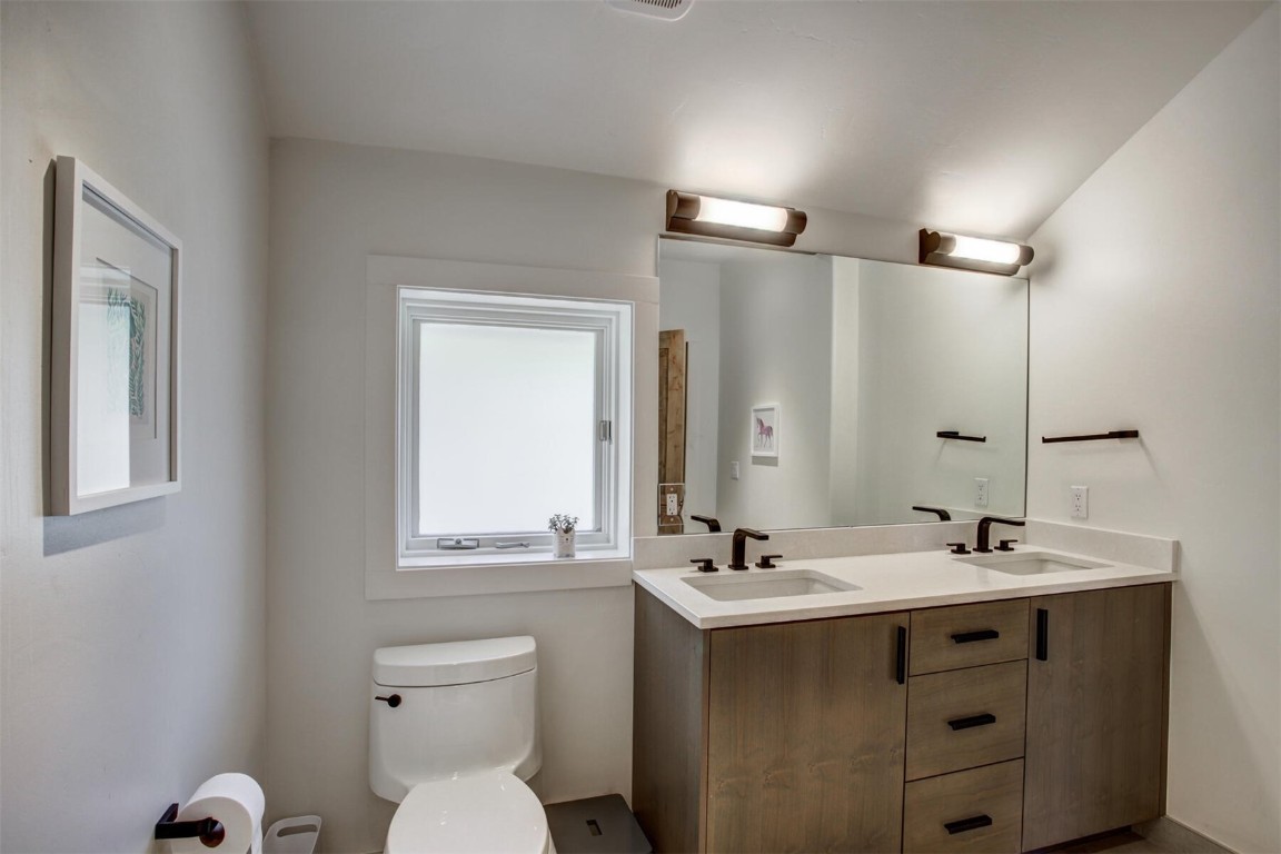 203 Wellington Road Breckenridge, CO 80424 - Photo 20 of 42 a bathroom with a double vanity sink and mirror with toilet
