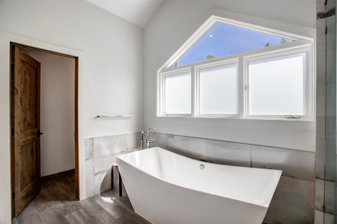 203 Wellington Road Breckenridge, CO 80424 - Photo 25 of 42 a bathroom with a bathtub and a window