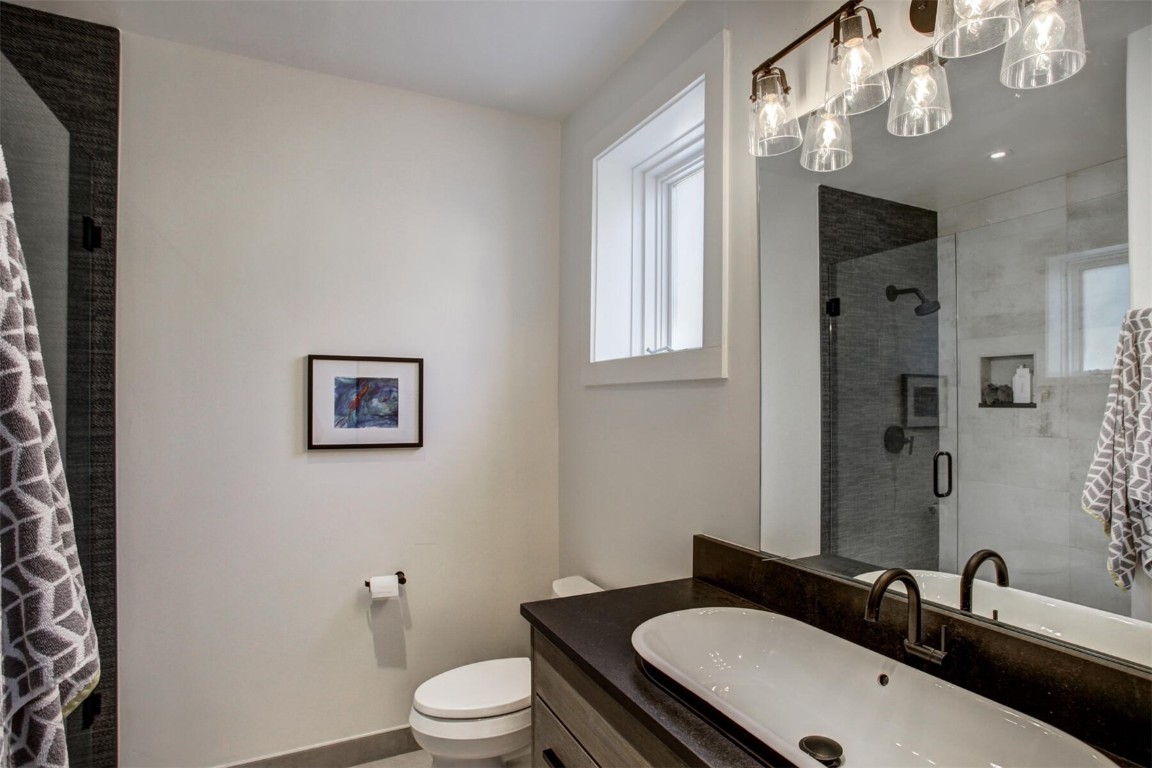 203 Wellington Road Breckenridge, CO 80424 - Photo 35 of 42 a bathroom with a sink a toilet and a mirror
