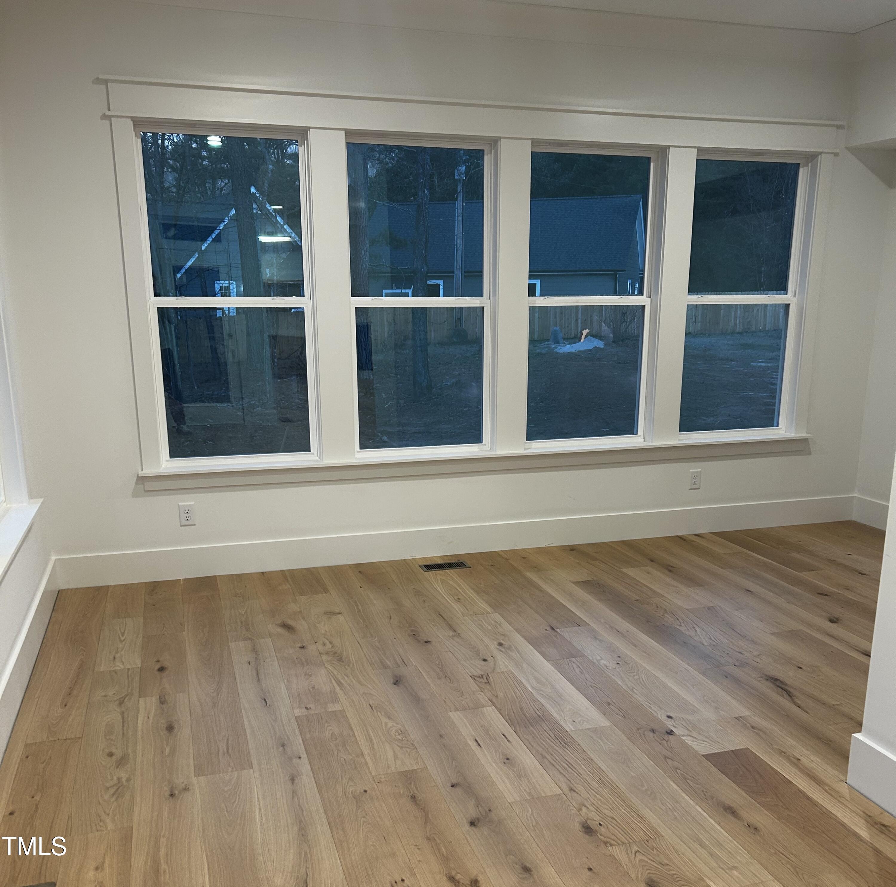 1008 Frank Bailey Road Wake Forest, NC 27587 - Photo 15 of 22 a view of an empty room with wooden floor and a window