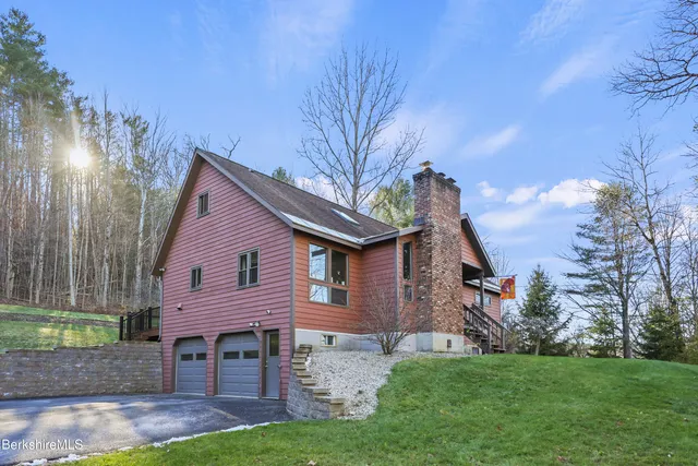 a front view of a house with a garden and yard
