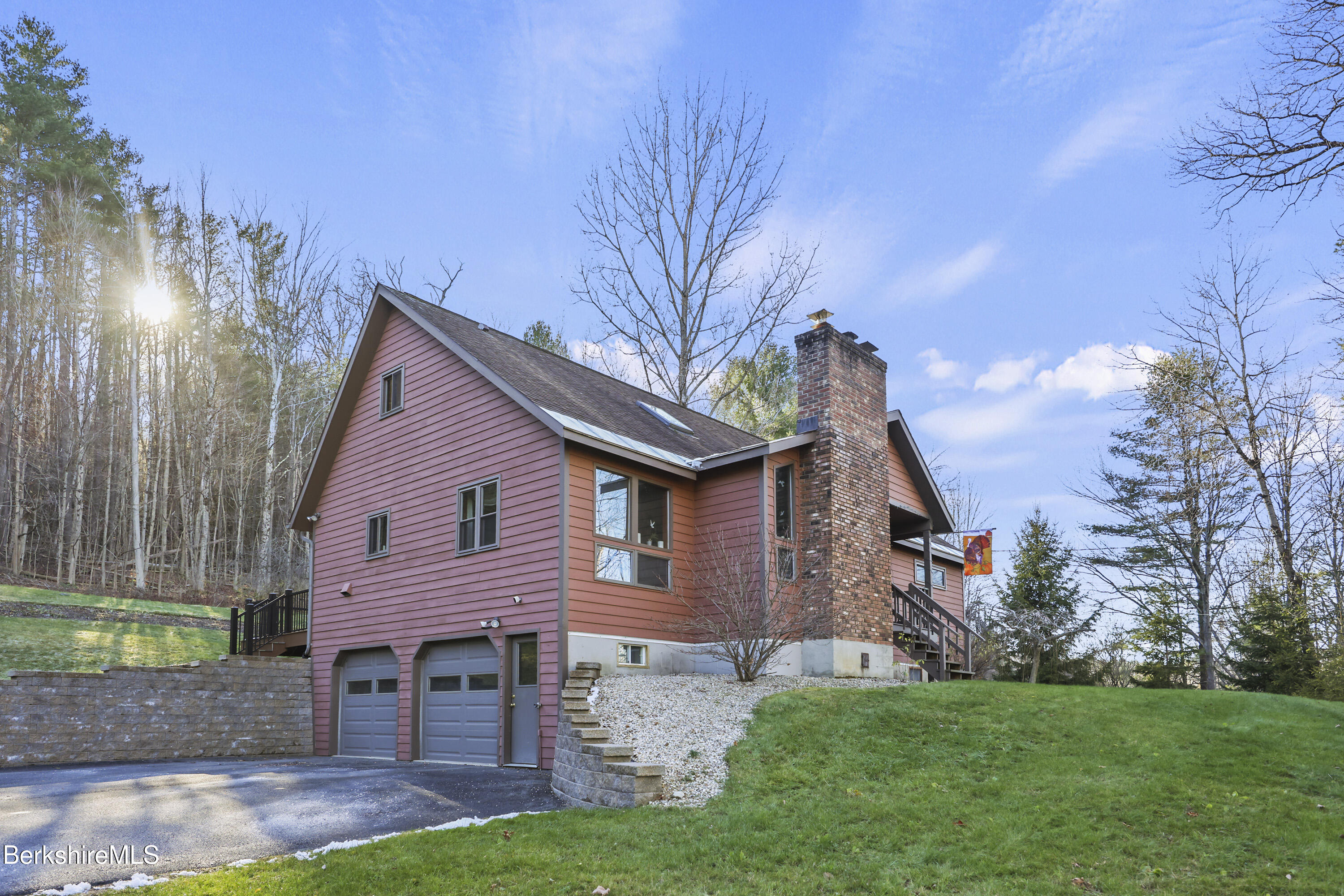 a front view of a house with a garden and yard