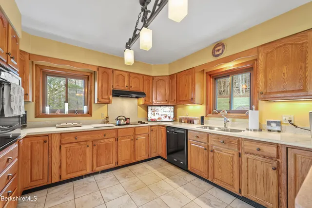 a large kitchen with a large window appliances and cabinets