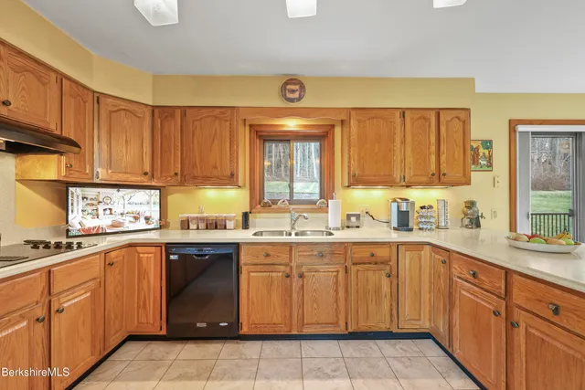 a kitchen with a sink stove top oven and cabinets