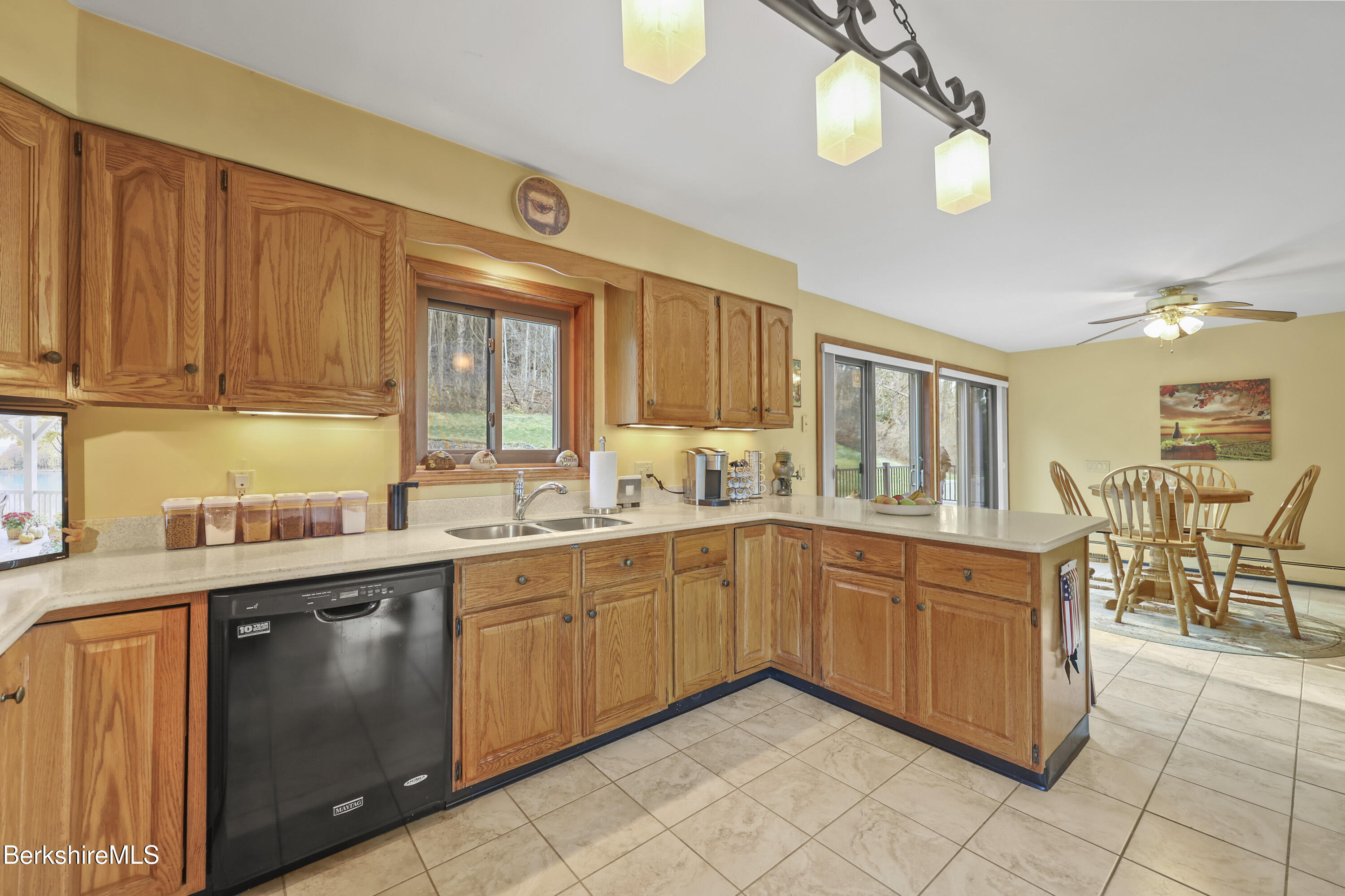 551 Tamarack Road Pittsfield, MA 01201 - Photo 19 of 51 a kitchen with stainless steel appliances granite countertop a sink and cabinets